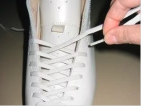 Threading laces through eyelets
